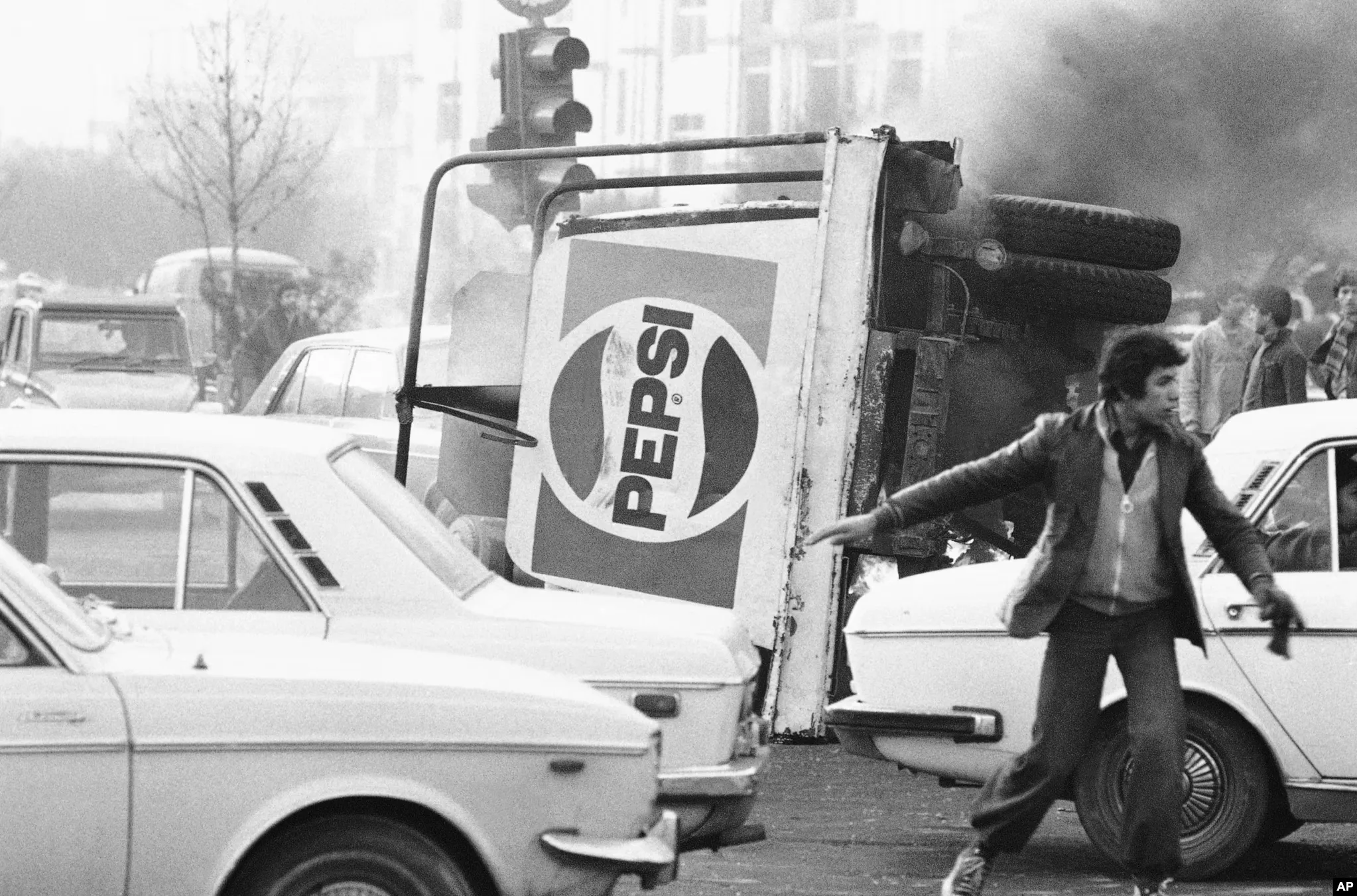 An overturned truck with a Pepsi logo burns in the center of Tehran during riots which paralyzed the city on December 27, 1978. (source AP)